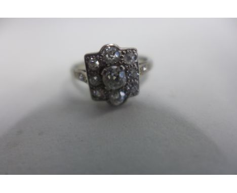 A very pretty 18ct white gold and platinum diamond ring, the central stone of approx 0.25cts surrounded by a further eight sm