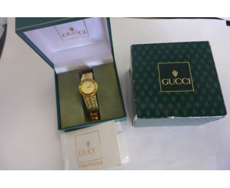 A ladies Gucci wristwatch, gold plated case and strap, model 33200.2.L, serial no 0094370 with box and original papers etc, w