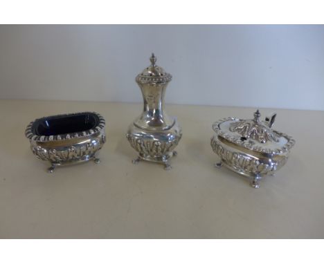 A silver Asprey and Co three piece cruet set including salt, mustard and pepperette, with classical style embossed decoration