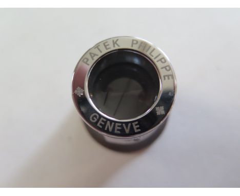 A Patek Philippe jewellers or watch makers eye glass, turned wood with inscribed chrome mount 