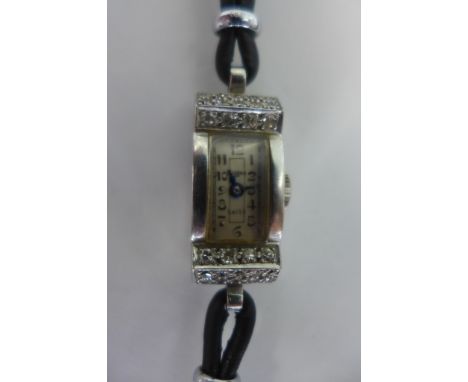 A pretty Art Deco style platinum and diamond Mappin wristwatch, the rectangular case set with 28 small round cut diamonds, wh