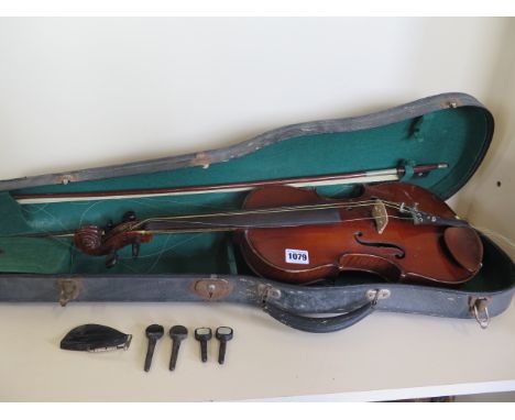 A late 19th/early 20th century violin in case with bow, mother of pearl inlay to tailpiece, also with spare turning pegs and 