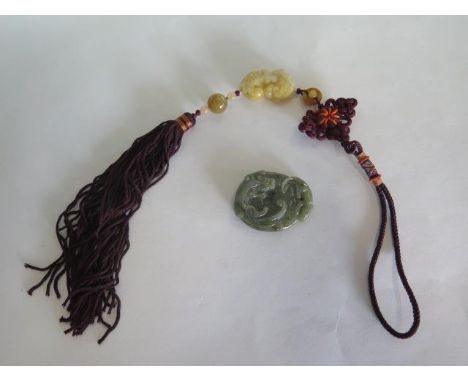 A carved jade pendant - 5x4cm - and a carved jade lion pendant on tassel pendant, length 4cm, both in good condition 