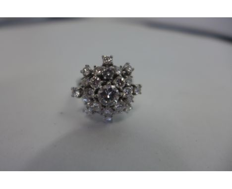 A very good diamond cluster ring in a five tier setting, the central stone measuring 0.5ct, surrounded by eight stones of 0.1