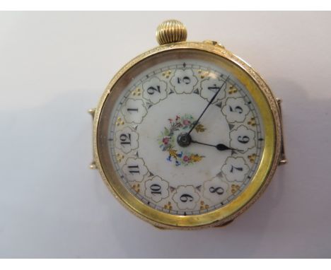 A very nice 18ct gold ladies fob wristwatch, beautiful gilded and decorated white enamel dial with Arabic numerals, the case 