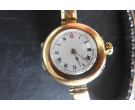 A very fine ladies 15ct gold Edwardian wristwatch, a very early design for a ladies watch, white enamel face with Roman numer