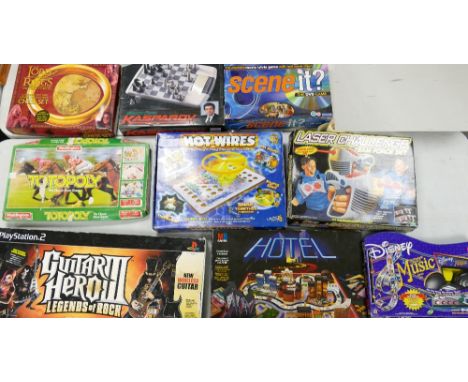 A large collection of boxed games ( un checked) including: Lord of the Rings Chess Set, Saitek Kasparov Chess Set, Totopoly, 
