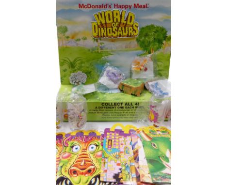 A  collection of  McDonald happy meal kid club toys and boxes to include:  Dragonettes together with plastic cups 
