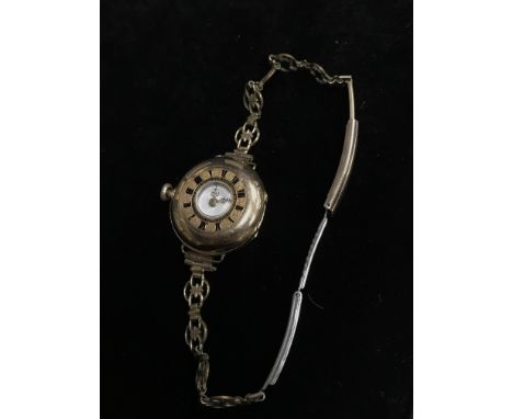 LADY'S BRACELET WATCH, the white enamel dial with numerals in black, the case stamped 18kt, along with a seed pearl set bar b