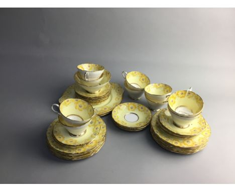 PARAGON TEA SERVICE, Cosmea pattern, decorated with yellow and pink flowerheads on a yellow ground, comprising 10 cups, 13 sa