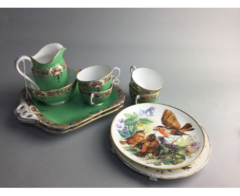 EARLY 20TH CENTURY ROYAL WORCESTER TEA SERVICE, decorated with floral reserves on a green ground, comprising six cups, five s