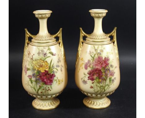 PAIR OF ROYAL WORCESTER VASES a pair of blush ivory vases, each painted with flowers to each side and with gilded handles and