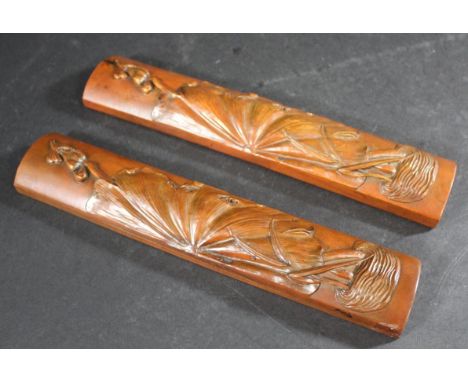 CHINESE WOODEN SCROLL WEIGHTS two carved wooden scroll weights of curved shape and narrow form, carved with flowers and folia