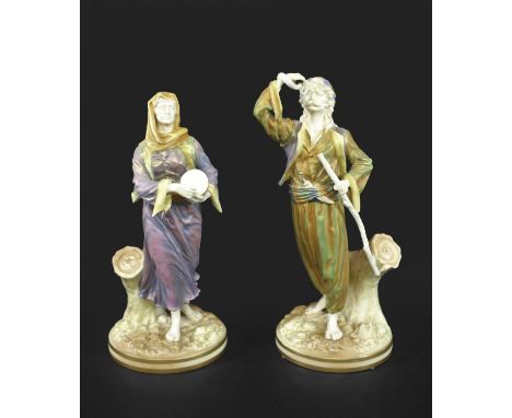 RARE ROYAL WORCESTER INDIAN FIGURES an unusual pair of Chinguin Indian figures, the male and female figures painted in a vari