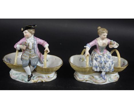 MEISSEN - PAIR OF TABLE SALTS modelled as a lady and gent in 18thc style clothing, each holding a posy of flowers between two