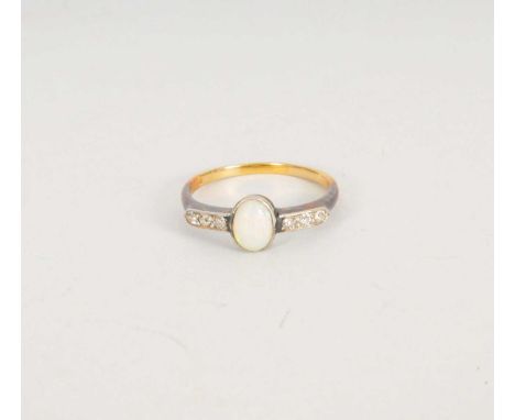 An opal and diamond ring, designed as a central oval cabochon opal collet set in white metal and flanked to each side by thre