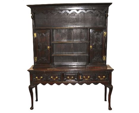 An early 18th century and later oak dresser base, the associated, later rack with a convex cornice above a shelf over two fur