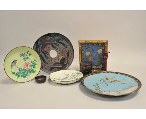 A large Japanese cloisonné enamel plate, decorated with a pair of cranes in flight over an icey lakeside and clear blue sky, 