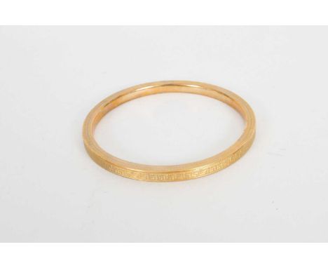 A 9ct gold bangle, with Greek key engraved decoration, hallmarked Birmingham 1923, weight approx 13.4g