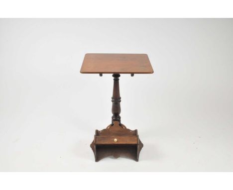 A small 19th century mahogany occastional tripod table with rounded tablet top over a turned stem and scrolled legs, 73cm hig