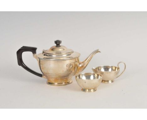 A silver teapot, William Neale &amp; Son Ltd, Birmingham 1934, with bakelite handle and finial, together with an associated s