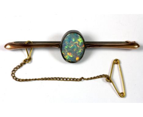 A Edwardian 9ct gold bar brooch set with a blue boulder opal (approx 11 x 14mm).