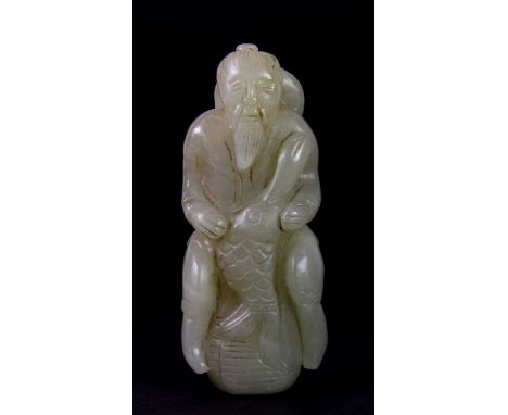 A Chinese carved jade/hardstone figure of a fisherman with a large carp, probably early 20th century, H. 8.5cm.