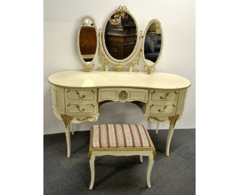 A 1960's cream painted and gilt kidney shaped dressing table and stool.