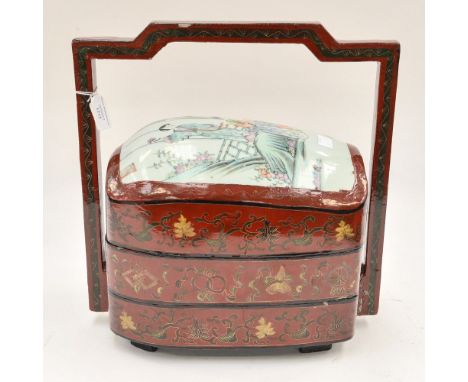 A 20th Century Chinese ceramic and lacquer food storage container with three layers and handle
