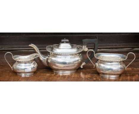 A three piece silver tea set comprising teapot with ebonised handle and finial, milk and sugar, Viners Ltd  (Emile Viner) 193