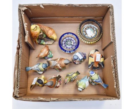 A collection of ten bisque Royal Worcester models of birds together with a Beswick model of a blue tit and two Perthshire pap