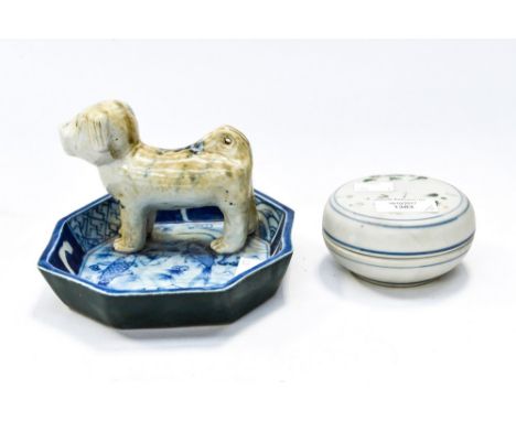 Chinese powder bowl and cover with blue and white trinket dish having dog decoration.