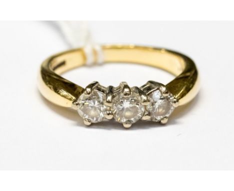 A diamond and 18ct yellow gold three stone ring, total diamond weight approximately one carat, ring size approximately 0½ cla