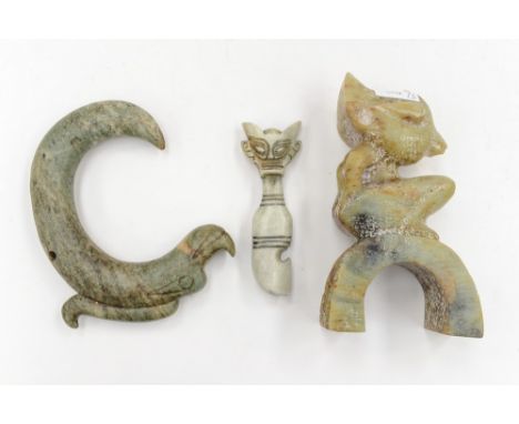 A carved jade mystical figure, sitting on a bridge
