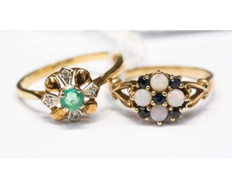 A yellow metal ring set with diamond chips, around an emerald with a 9ct ring set with four opals and sapphires as a cluster,