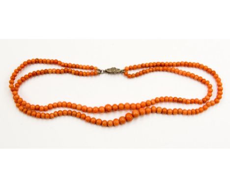 An Edwardian double row graduated coral necklace with marcasite set clasp 
