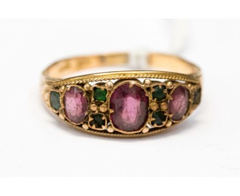 A Victorian gem set 15ct rose gold ring, set with three oval graduated garnets, with green stones set in between,  size N 1/2