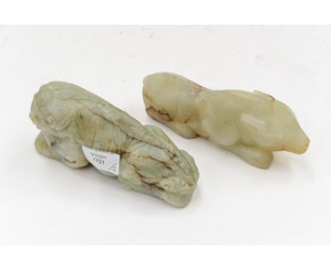 Two carved jade figures, a recumbent lion and a recumbent pig