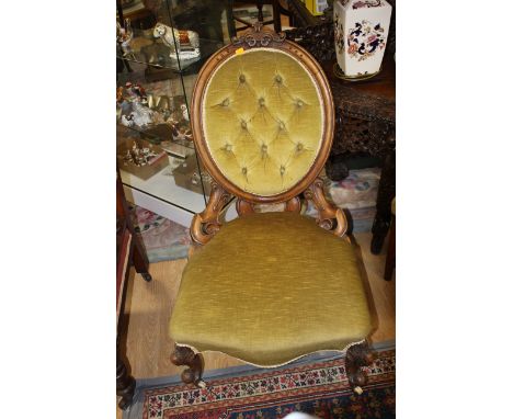 A Victorian walnut deep button backed upholstered ladies chair