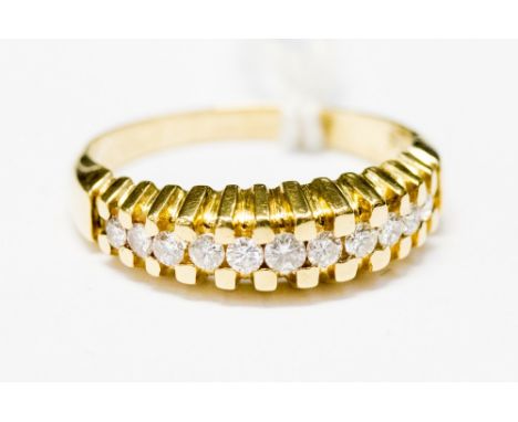 A diamond yellow metal dress ring, eleven small round brilliant cut diamonds, ring size P½, gross weight approx 4.1 grams, st