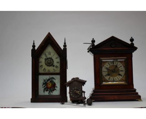 A Victorian mantle clock with brass fittings, cream dial with black Roman numerals and gilded fleur-de-lis decoration with ke