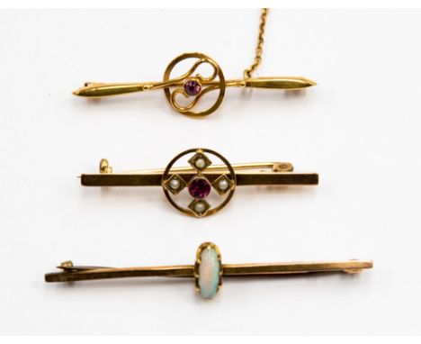 Three 9ct gold bar brooches, one set with a fire opal and other set with amethyst and one with seed pearls (3)