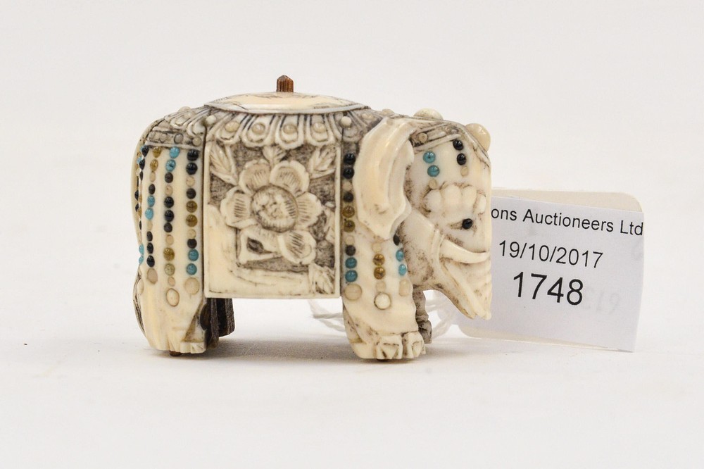 An ivory carved Elephant, inlaid with coloured stones