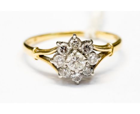 An 18ct gold diamond flower cluster ring, set with nine stones, size R, with a total gross weight of approx 3.1gms