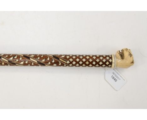 A 19th Century walking cane with carved ivory snarling Leopard head knop; the hardwood stick fully inlaid (1) 