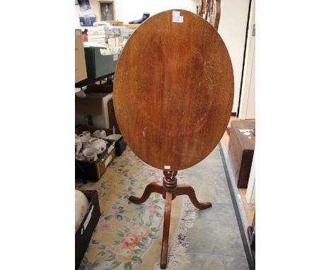 A 19th Century mahogany oval tilt top tripod table