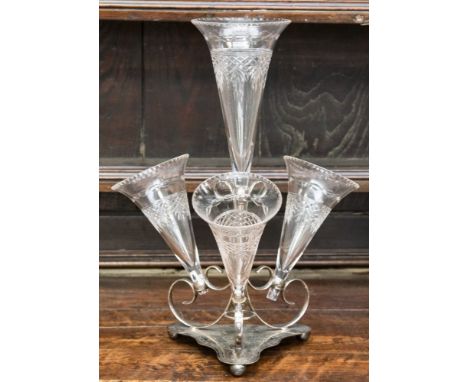 An Edwardian silver plate epergne, with four detachable cut-glass trumpet shaped vases, the trefoil shaped stand bright-cut e