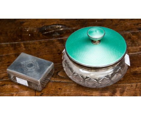 A cut glass powder bowl, enamelled and silver cover being engine turned, Birmingham 1932 with down powder puff, with a glass 