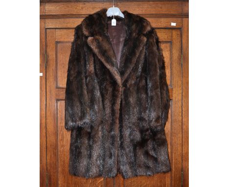 A Musquash thigh length coat, having shawl collar