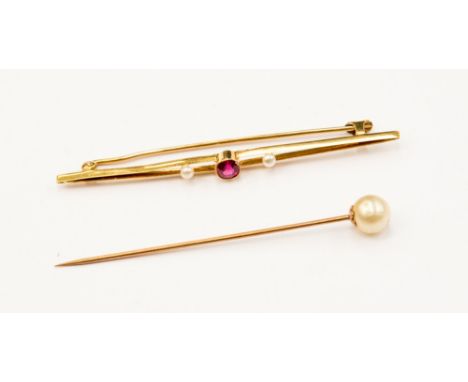 An eighteen carat gold bar brooch, set with a central ruby and two seed pearls, circa 1917/18, together with a 'pearl' finial